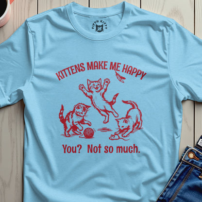 Light blue t-shirt with red text and graphic of three playful kittens.