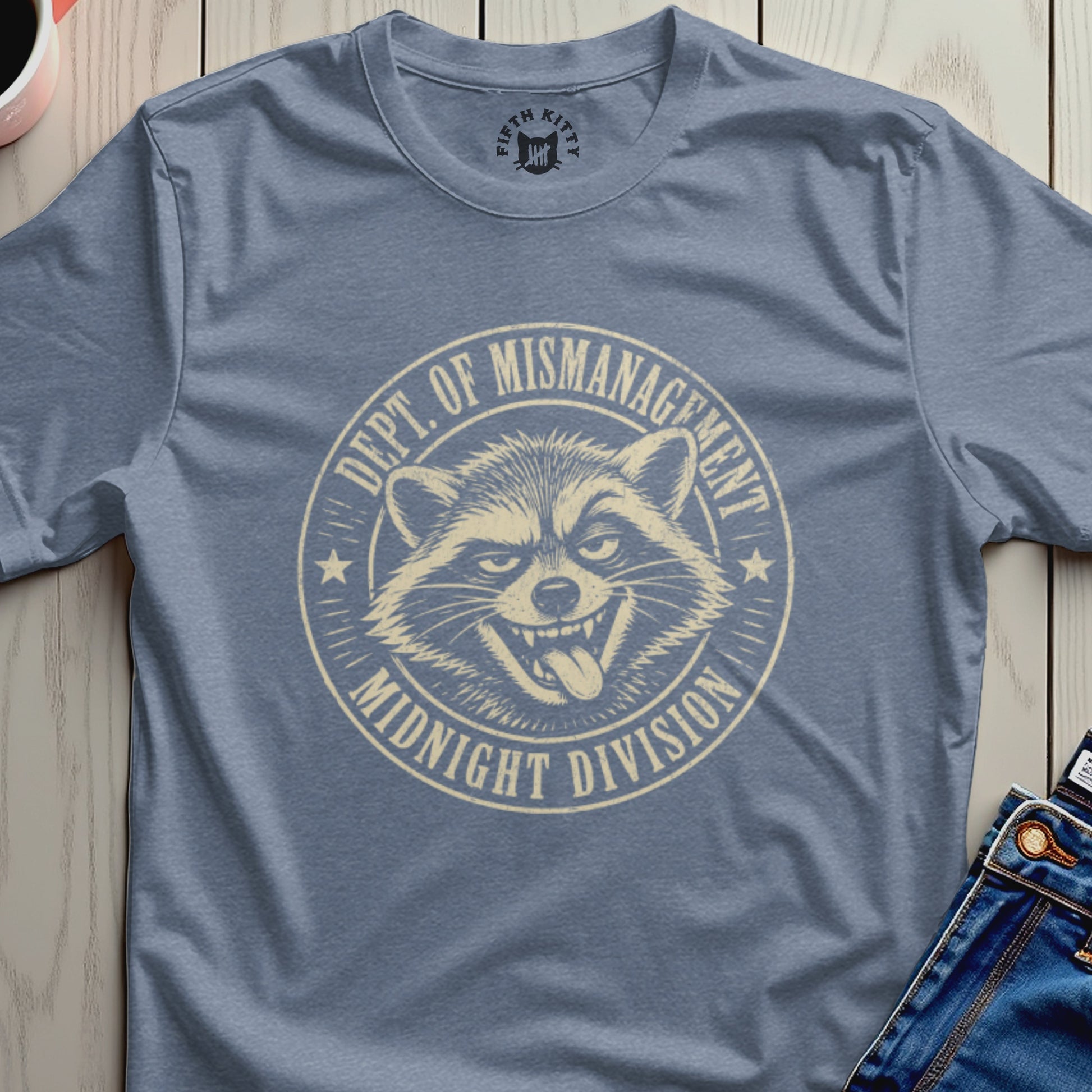 Blue t-shirt with "Dept. of Mismanagement Midnight Division" raccoon graphic.