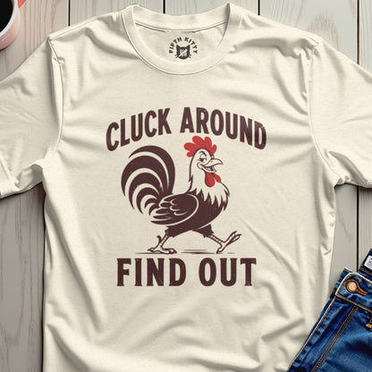 Cream t-shirt with "CLUCK AROUND" and a rooster above "FIND OUT".