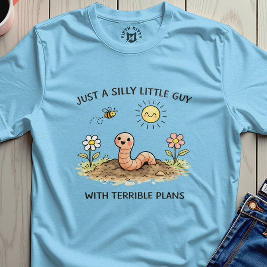 Light blue t-shirt with a cartoon worm and text "JUST A SILLY LITTLE GUY WITH TERRIBLE PLANS."