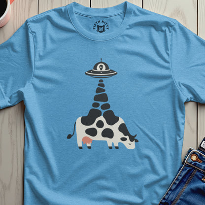 Blue t-shirt with a graphic of a cow being abducted by a UFO.