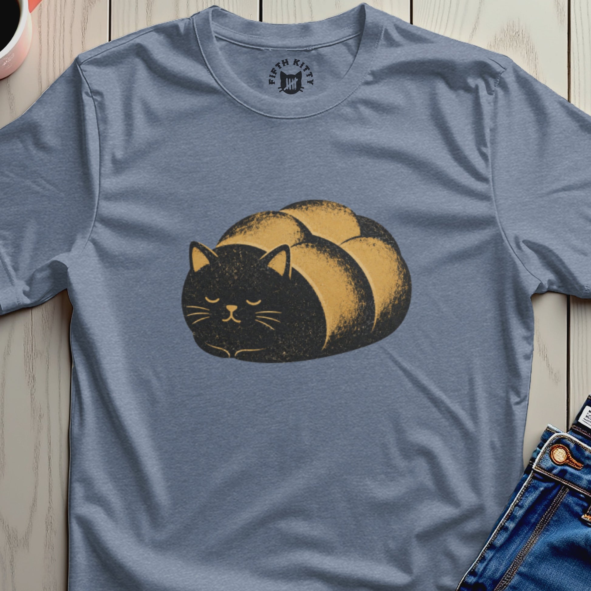 Blue t-shirt with a black cat rolled up in a bread loaf design and Fifth Kitty logo.