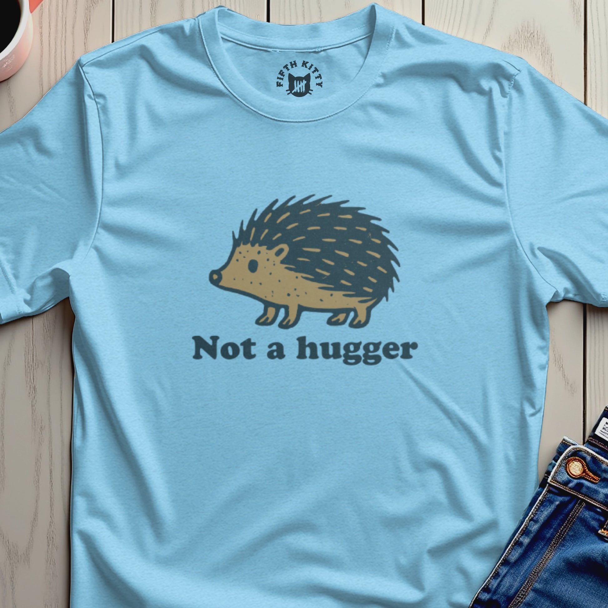 Light blue t-shirt with a hedgehog graphic and "Not a hugger" text.