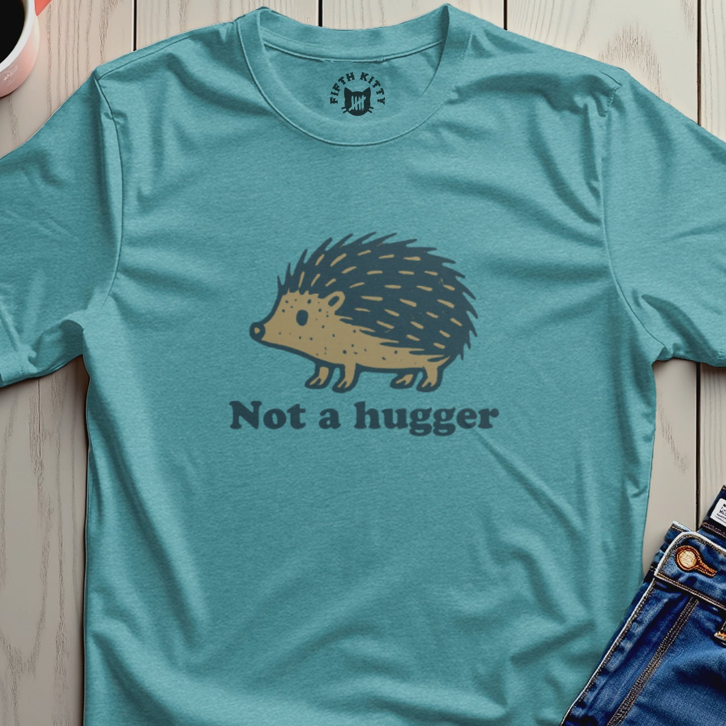 Teal t-shirt with a stylized hedgehog graphic and "Not a hugger" text.