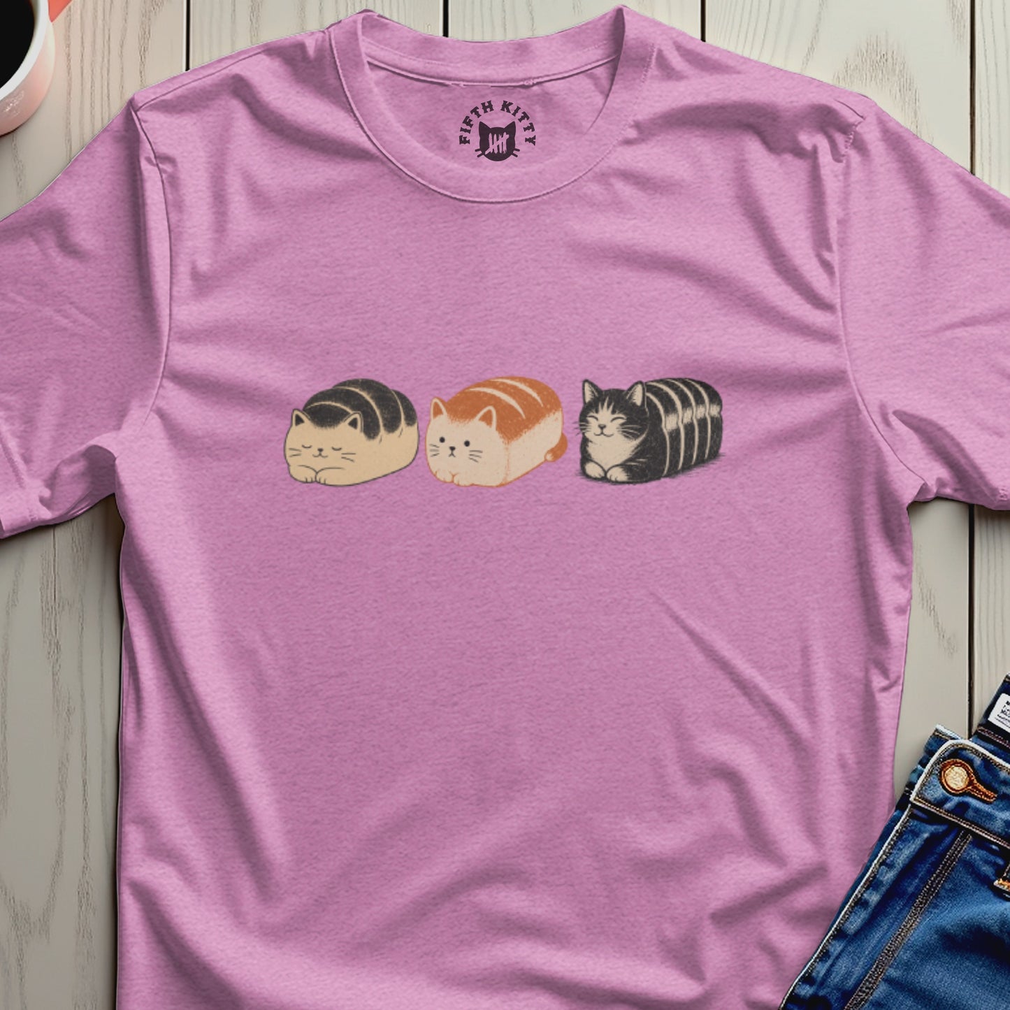 Pink t-shirt with three loaf-shaped cats and Fifth Kitty logo on collar.