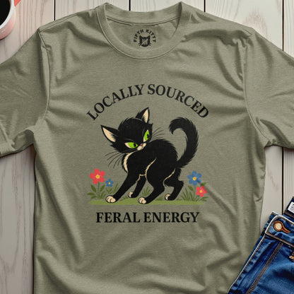 Black cat with green eyes, "Locally Sourced Feral Energy" text, and flowers on a t-shirt.