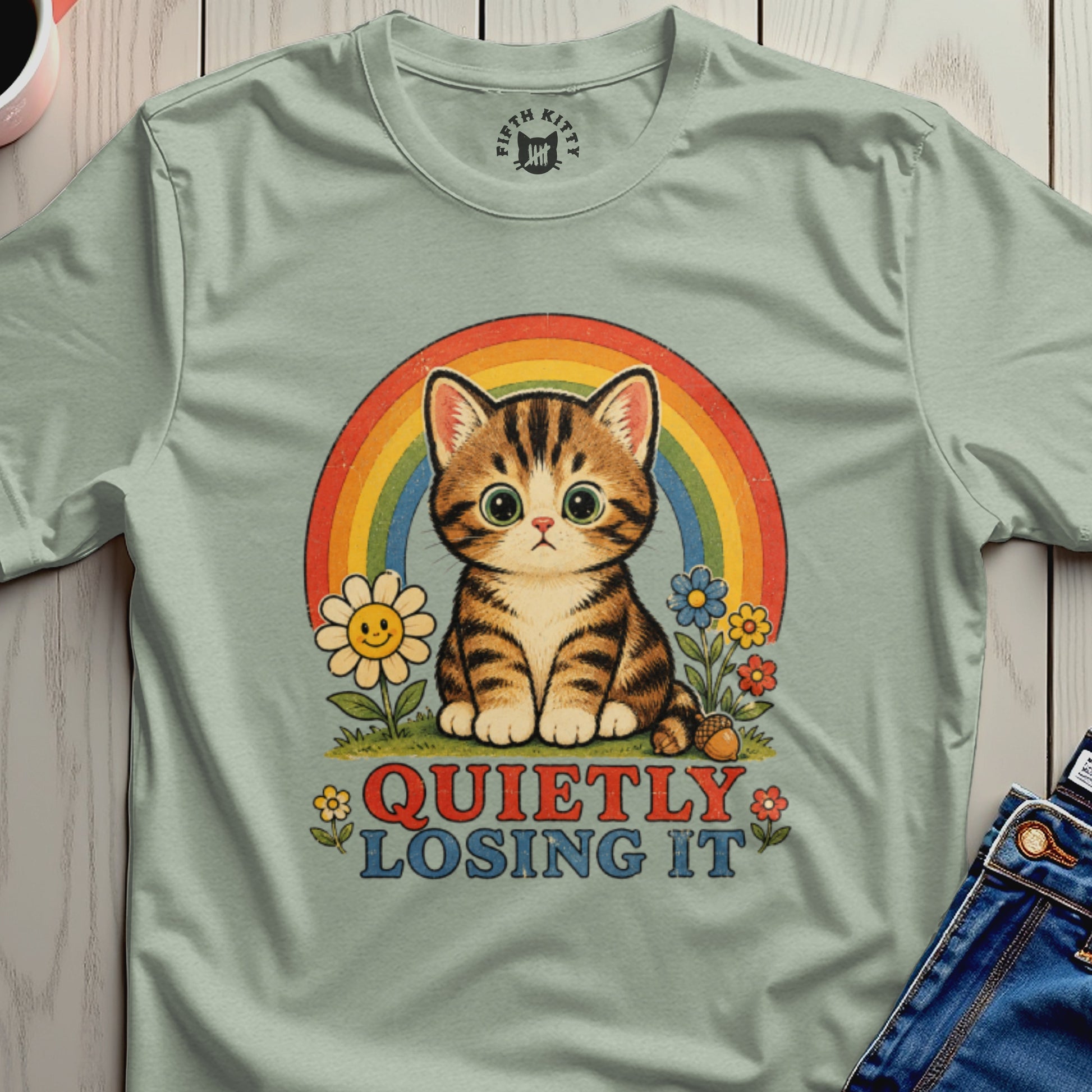 Tabby cat in front of rainbow with flowers and text "QUIETLY LOSING IT".