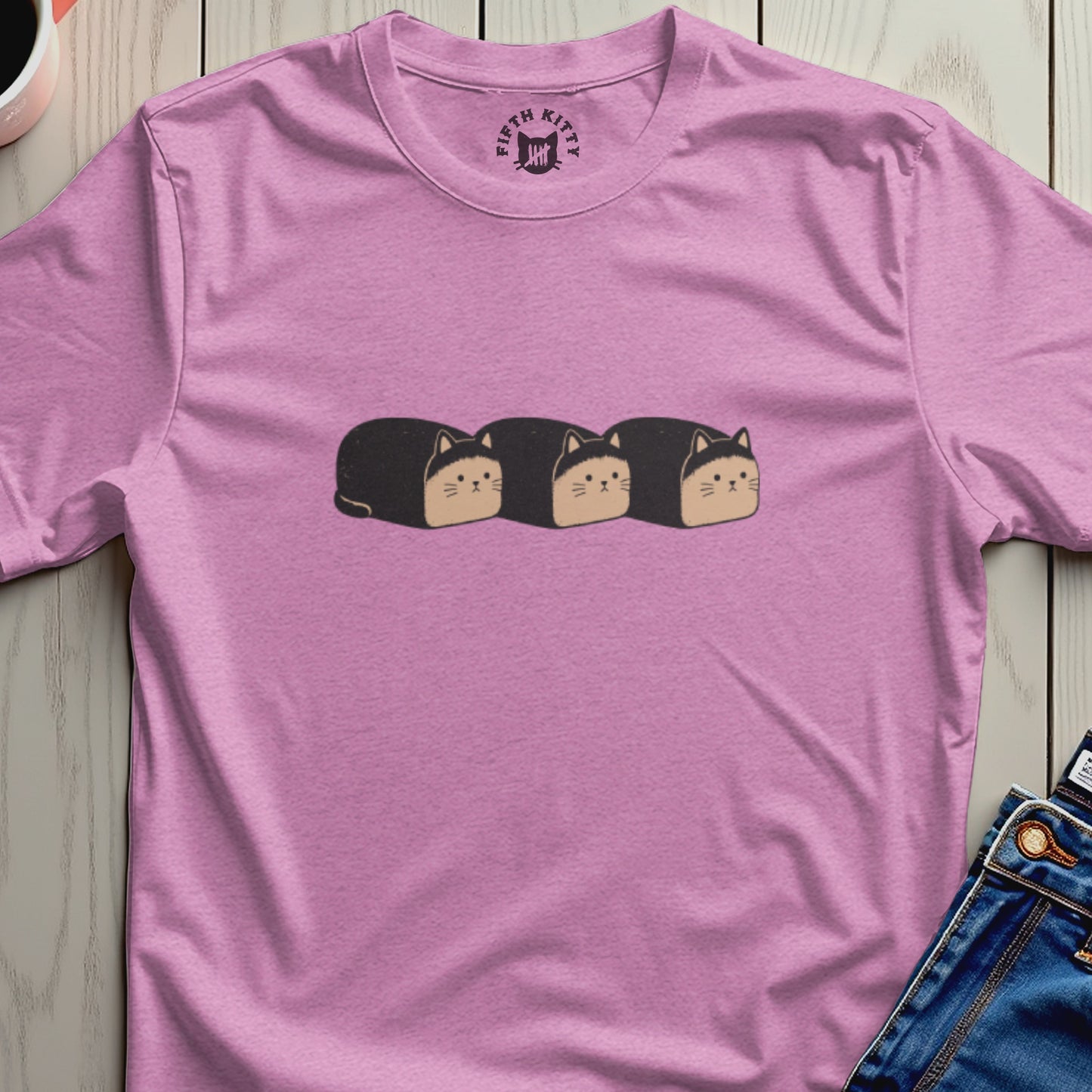 Pink t-shirt with a graphic of three black cat-shaped loaves of bread.