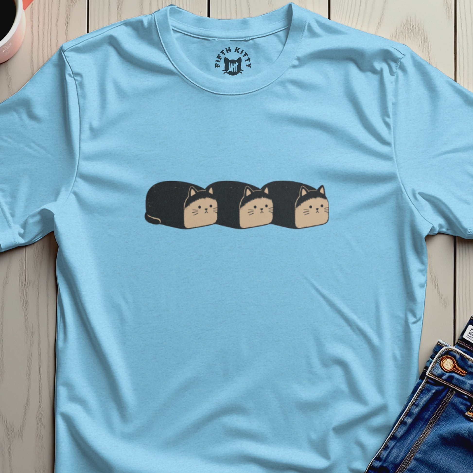 Light blue t-shirt with a graphic of three black cat loaves and "FIFTH KITTY" logo.