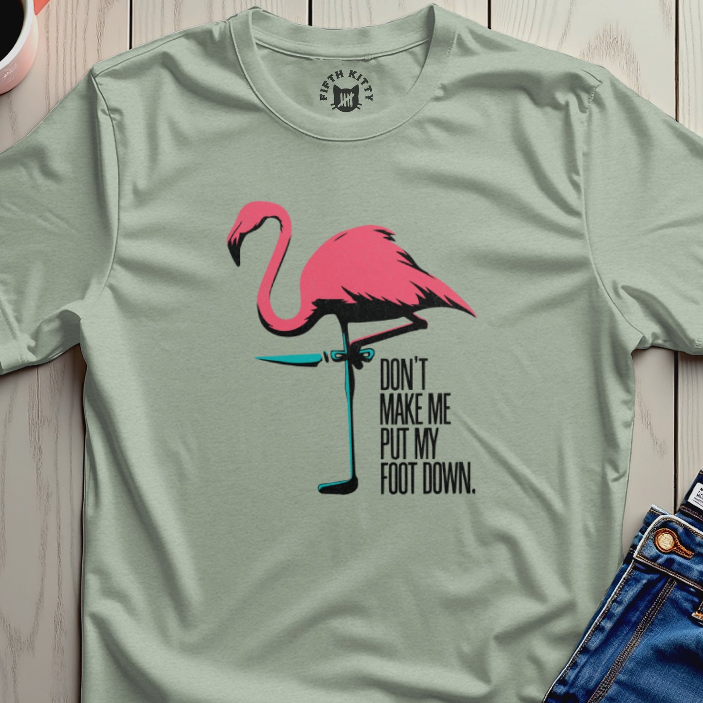 T-shirt with a pink flamingo and text "DON'T MAKE ME PUT MY FOOT DOWN".