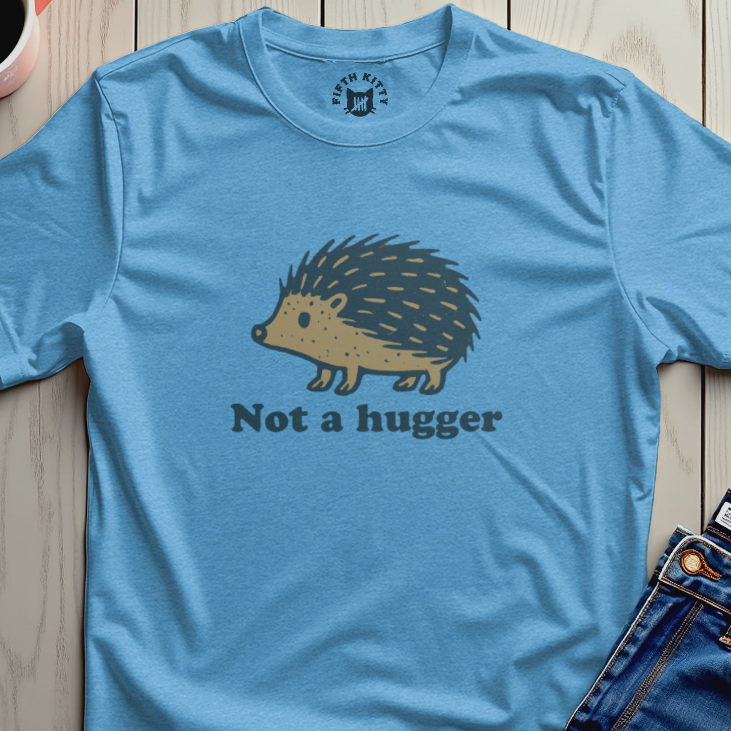 Light blue t-shirt with a hedgehog graphic and "Not a hugger" text.