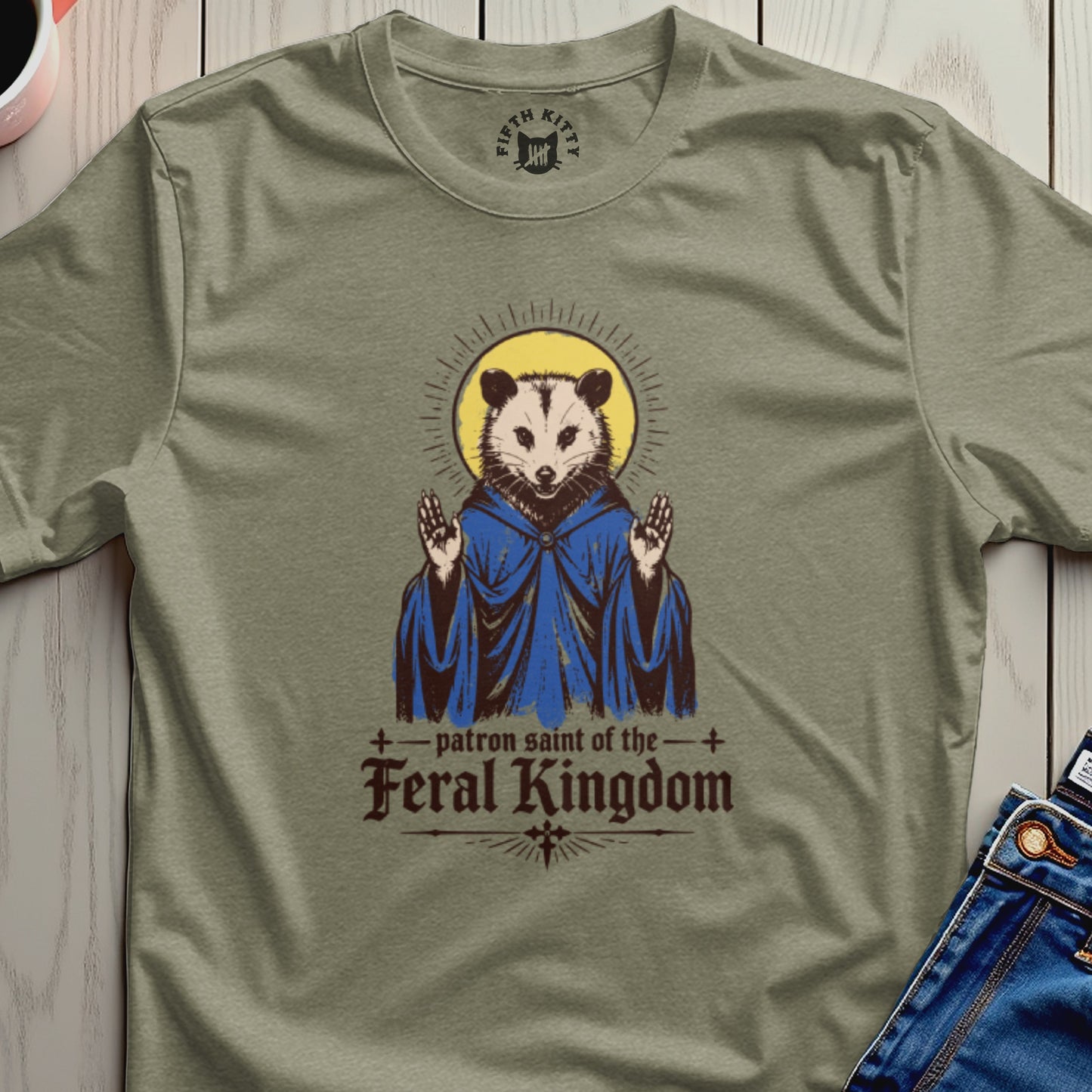 Feral Kingdom patron saint t-shirt with a rat in blue robes and halo.