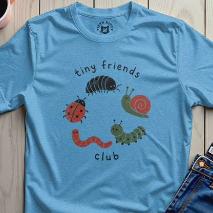 Light blue t-shirt with "tiny friends club" and illustrations of bugs.