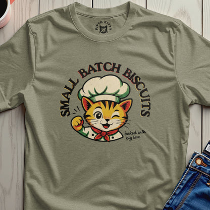 Cat chef winking and holding up a paw, with text "SMALL BATCH BISCUITS baked with big love."
