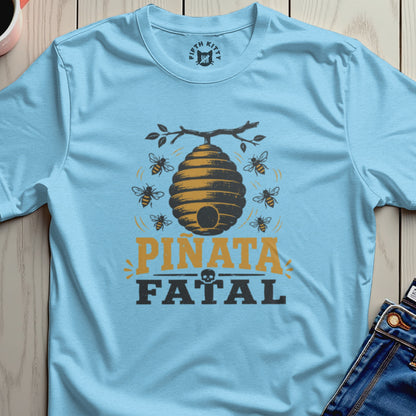 Light blue t-shirt with a beehive graphic and the words "Piñata Fatal".