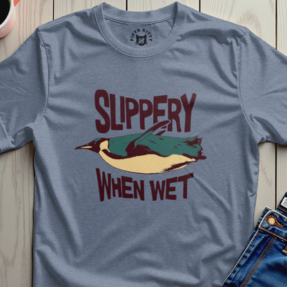 Blue t-shirt with a penguin graphic and the text "SLIPPERY WHEN WET".
