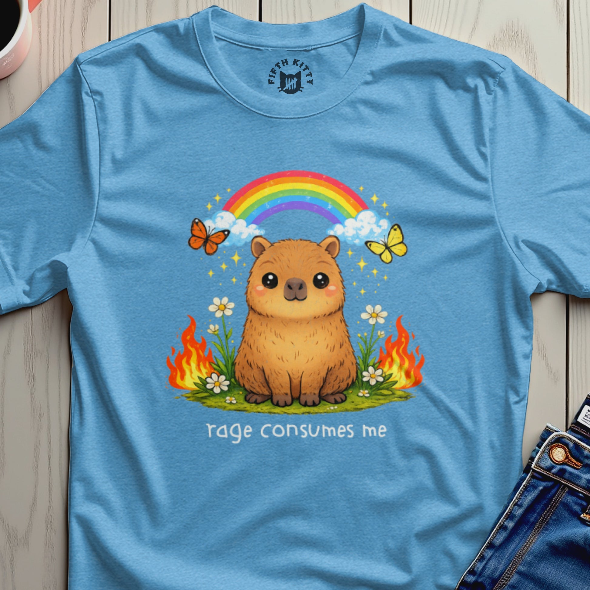 Capybara with butterflies, rainbow, and flowers, text "rage consumes me".
