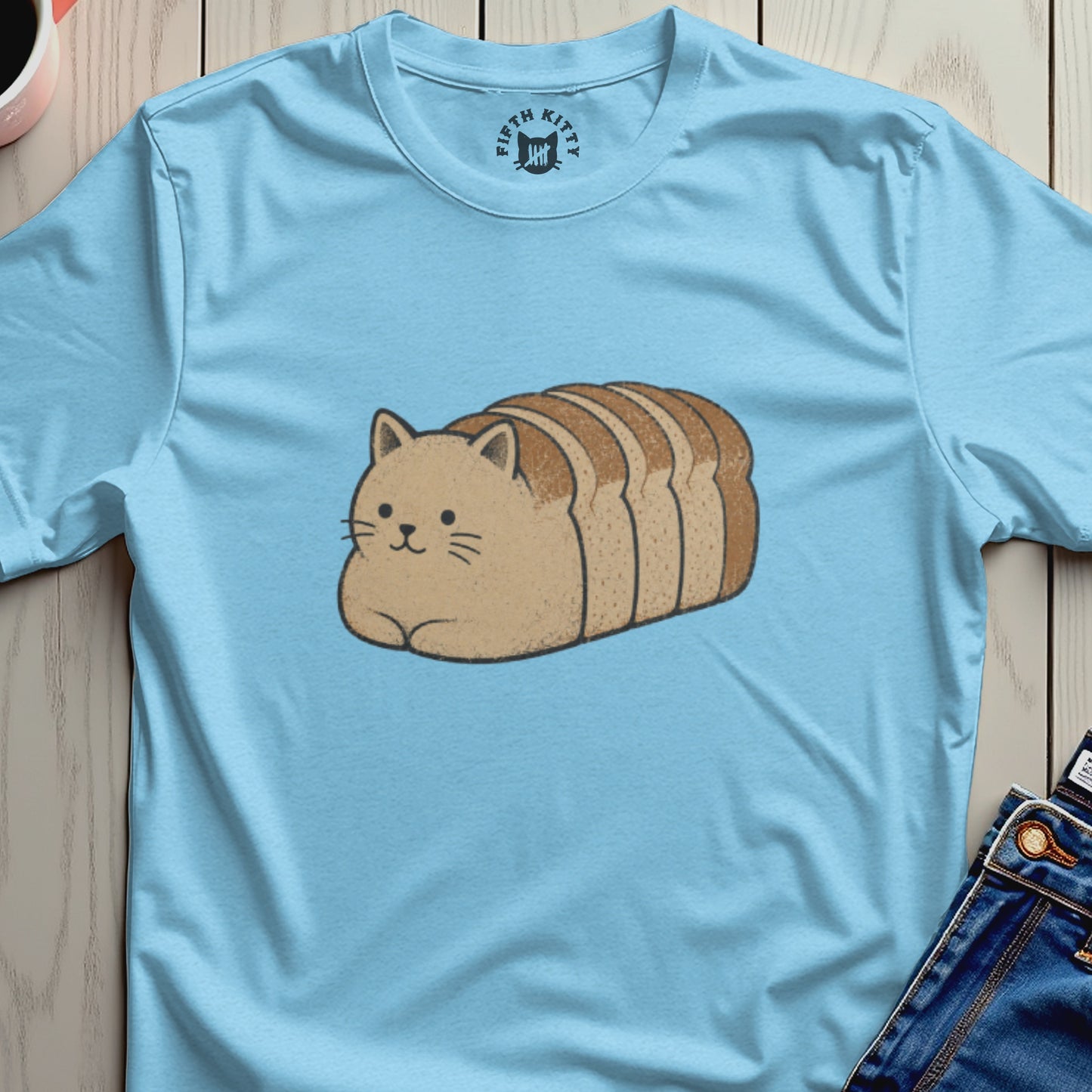 Light blue t-shirt with a cartoon cat shaped like a loaf of bread.