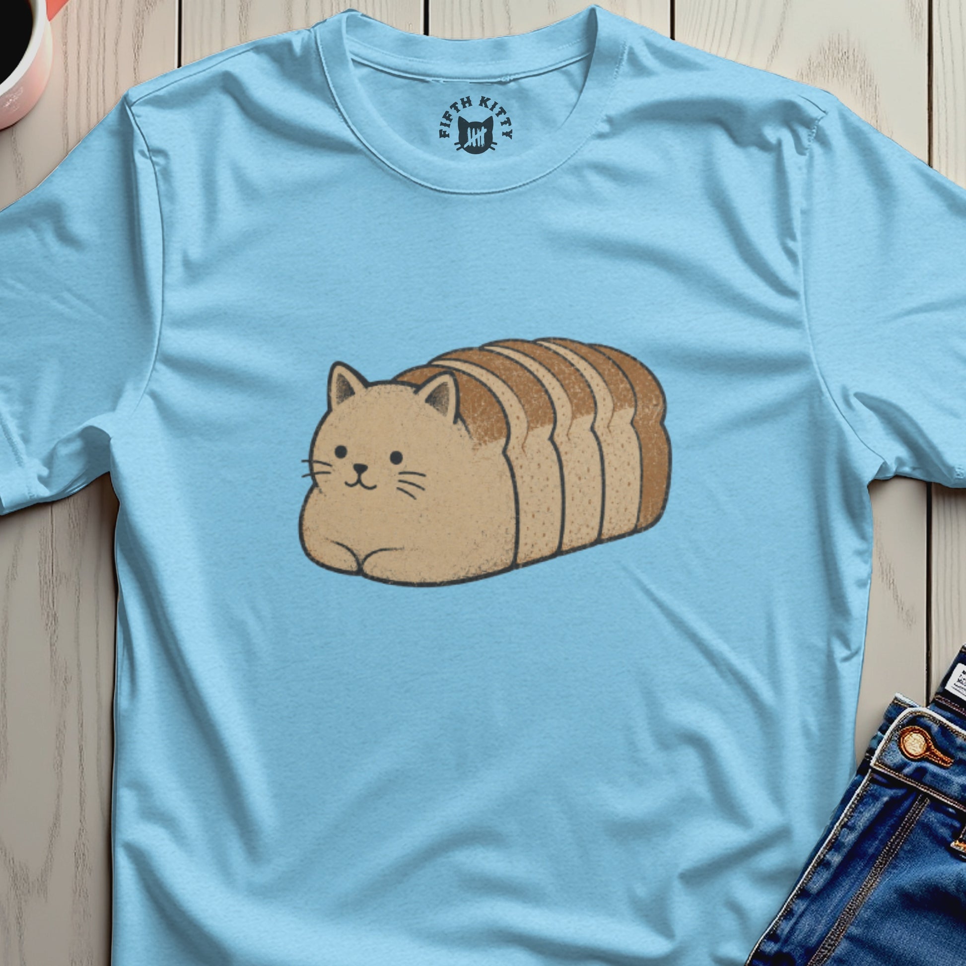 Light blue t-shirt with a cartoon cat shaped like a loaf of bread.