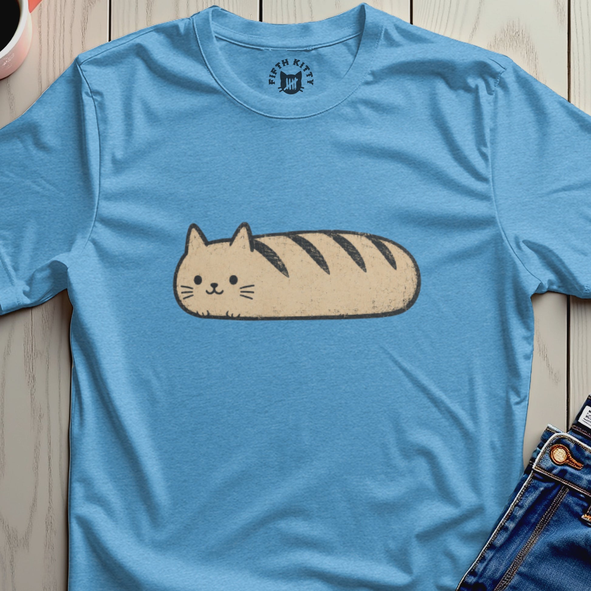 Blue t-shirt with a cartoon cat shaped like a loaf of bread.