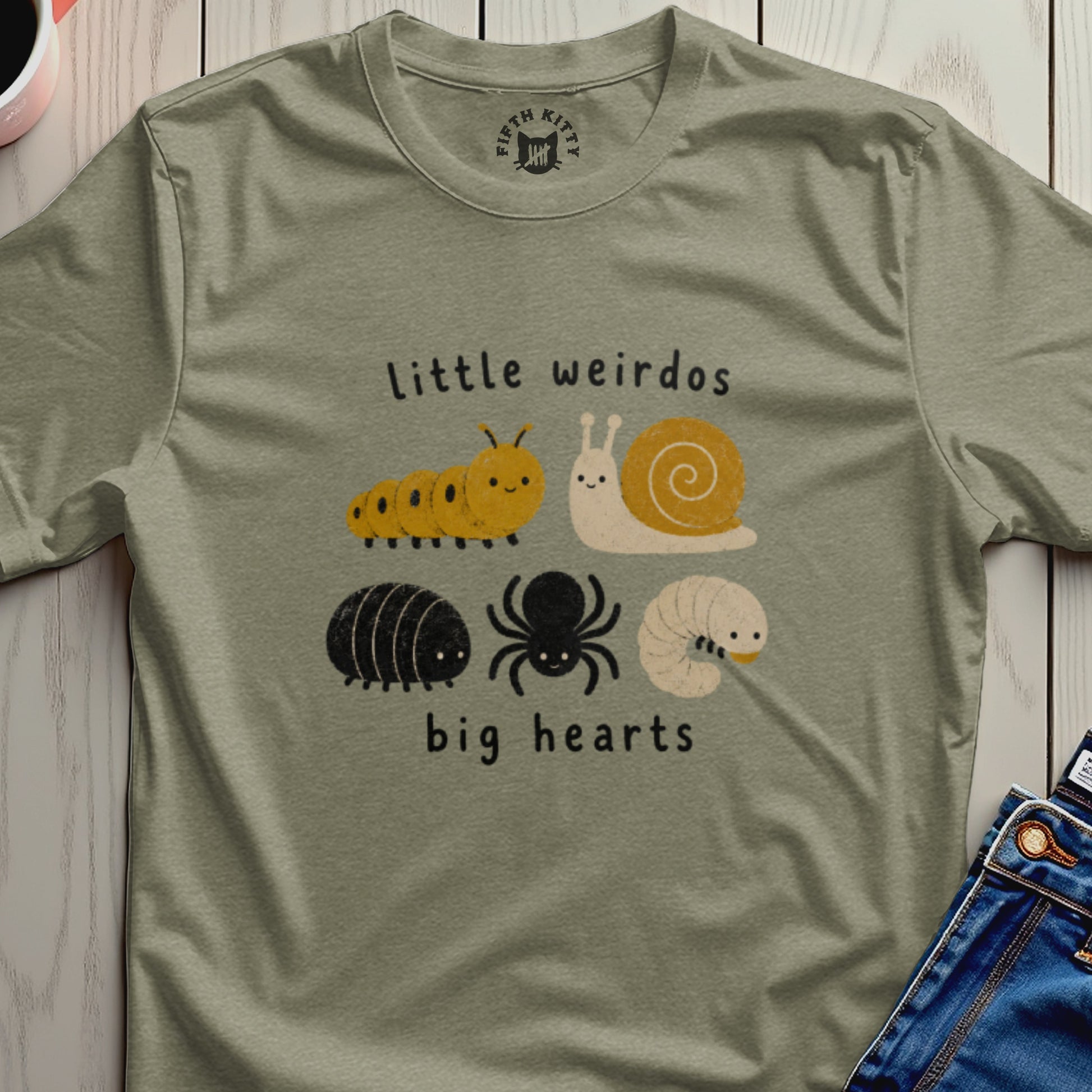 Green t-shirt with "little weirdos big hearts" text and illustrations of bugs.