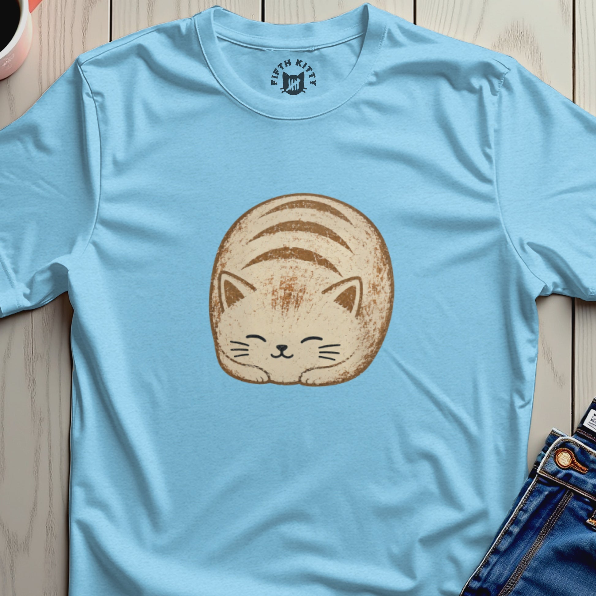 Light blue t-shirt with round, smiling cat graphic and "Fifth Kitty" logo.