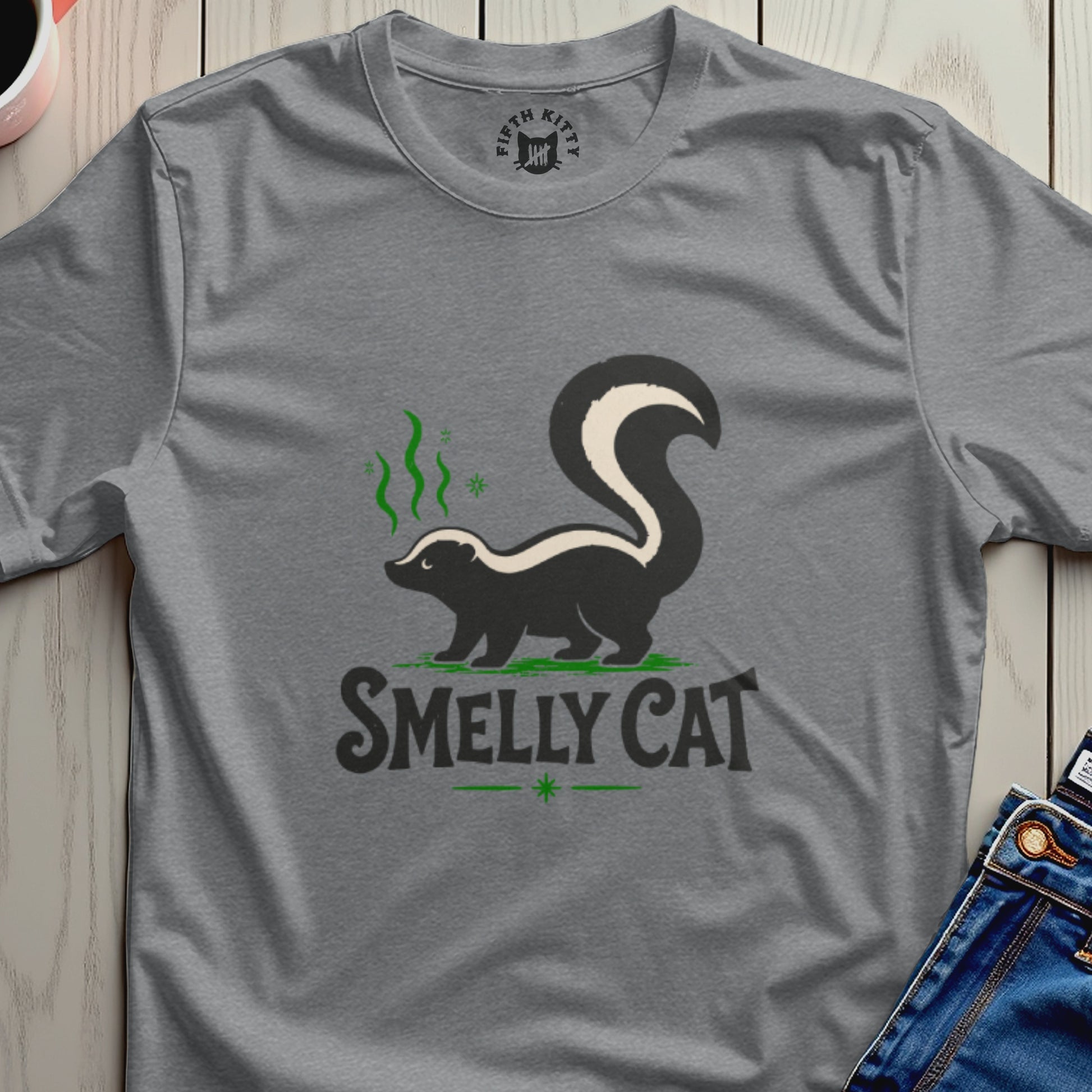 T-shirt with a skunk graphic and the text "SMELLY CAT".