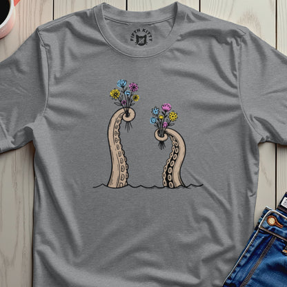 Two octopus tentacles holding bouquets of colorful flowers.