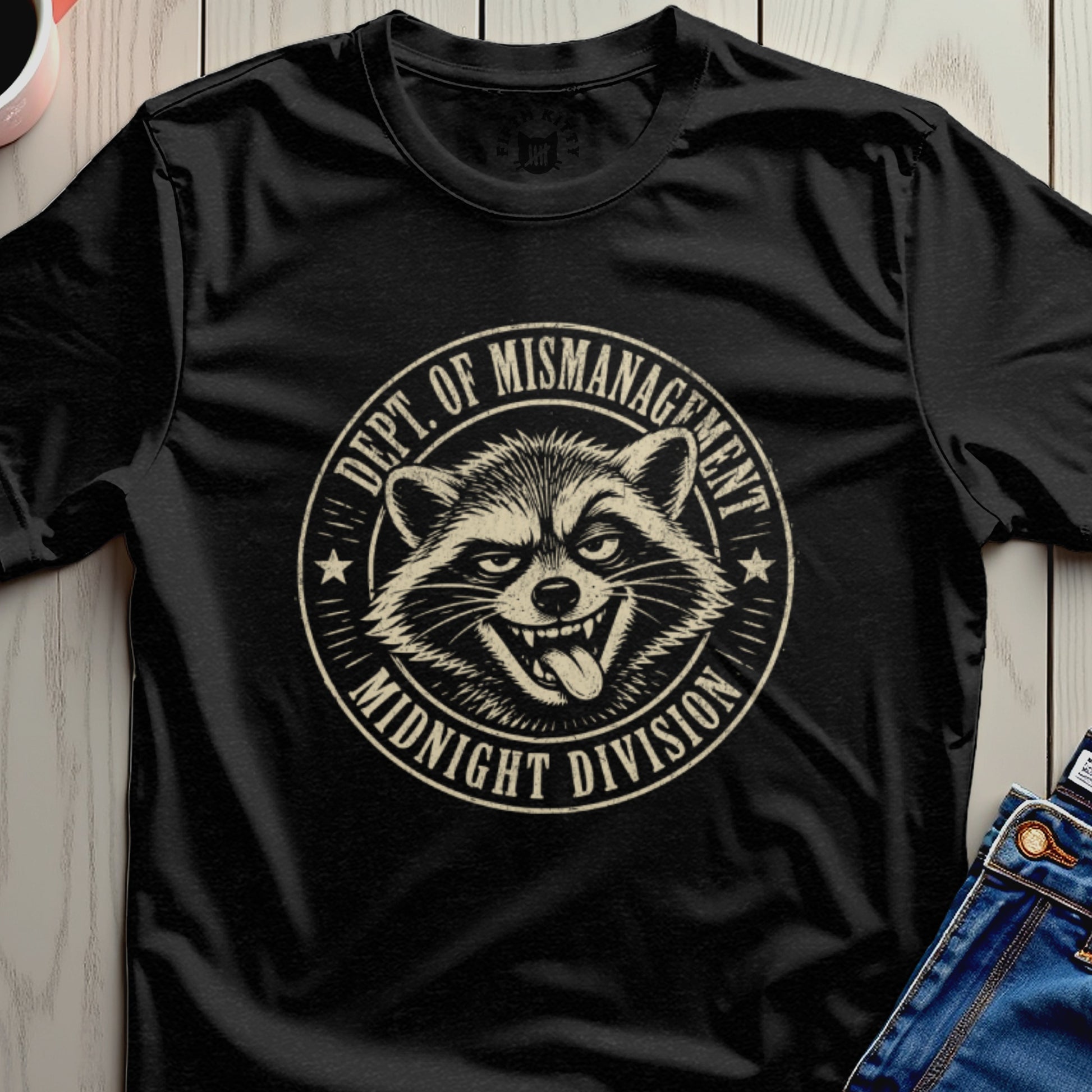 Black t-shirt with a raccoon graphic and "DEPT. OF MISMANAGEMENT MIDNIGHT DIVISION" text.