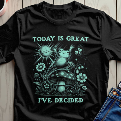 Black t-shirt with frog on mushroom, sun, and bee graphic, text reads "TODAY IS GREAT I'VE DECIDED".