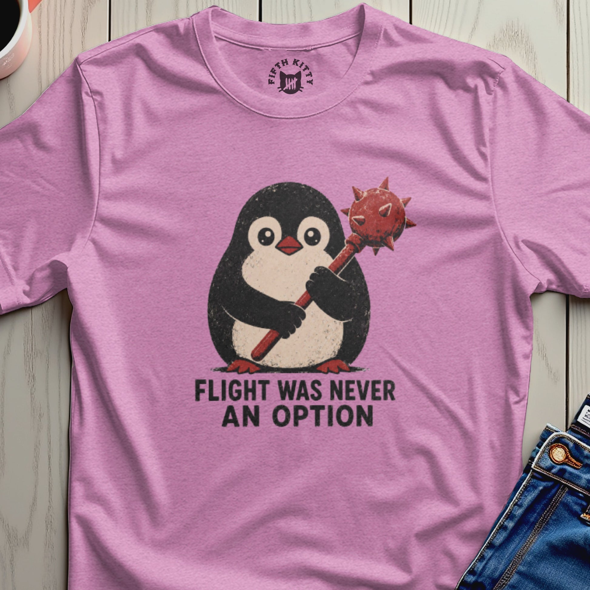 Pink t-shirt with a graphic of a penguin holding a mace, reading "Flight was never an option."