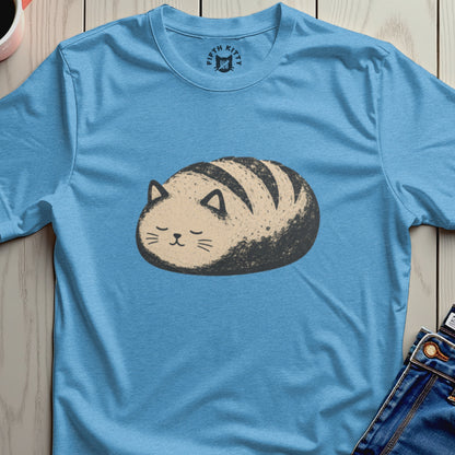Blue t-shirt with a cartoon drawing of a cat shaped like a loaf of bread.
