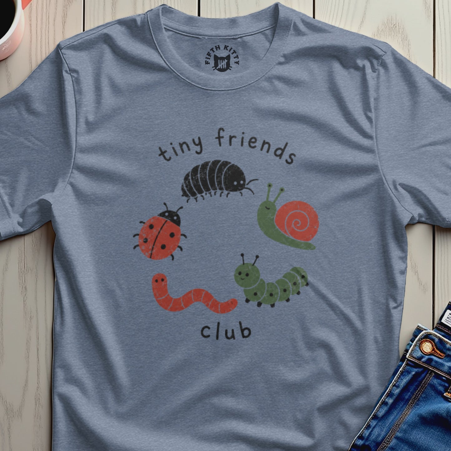 Blue t-shirt with "tiny friends club" graphic featuring cartoon insects.