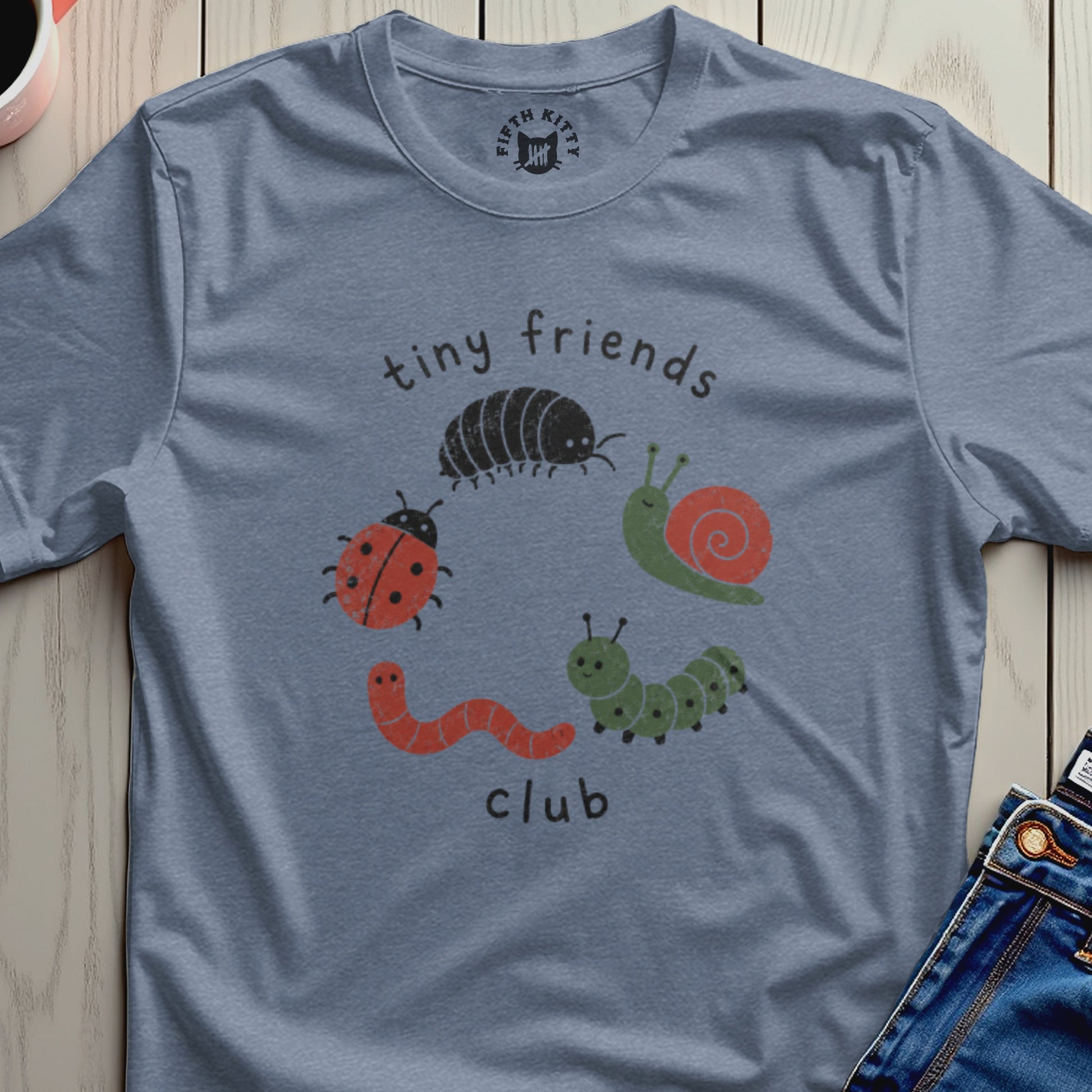 Blue t-shirt with "tiny friends club" graphic featuring cartoon insects.