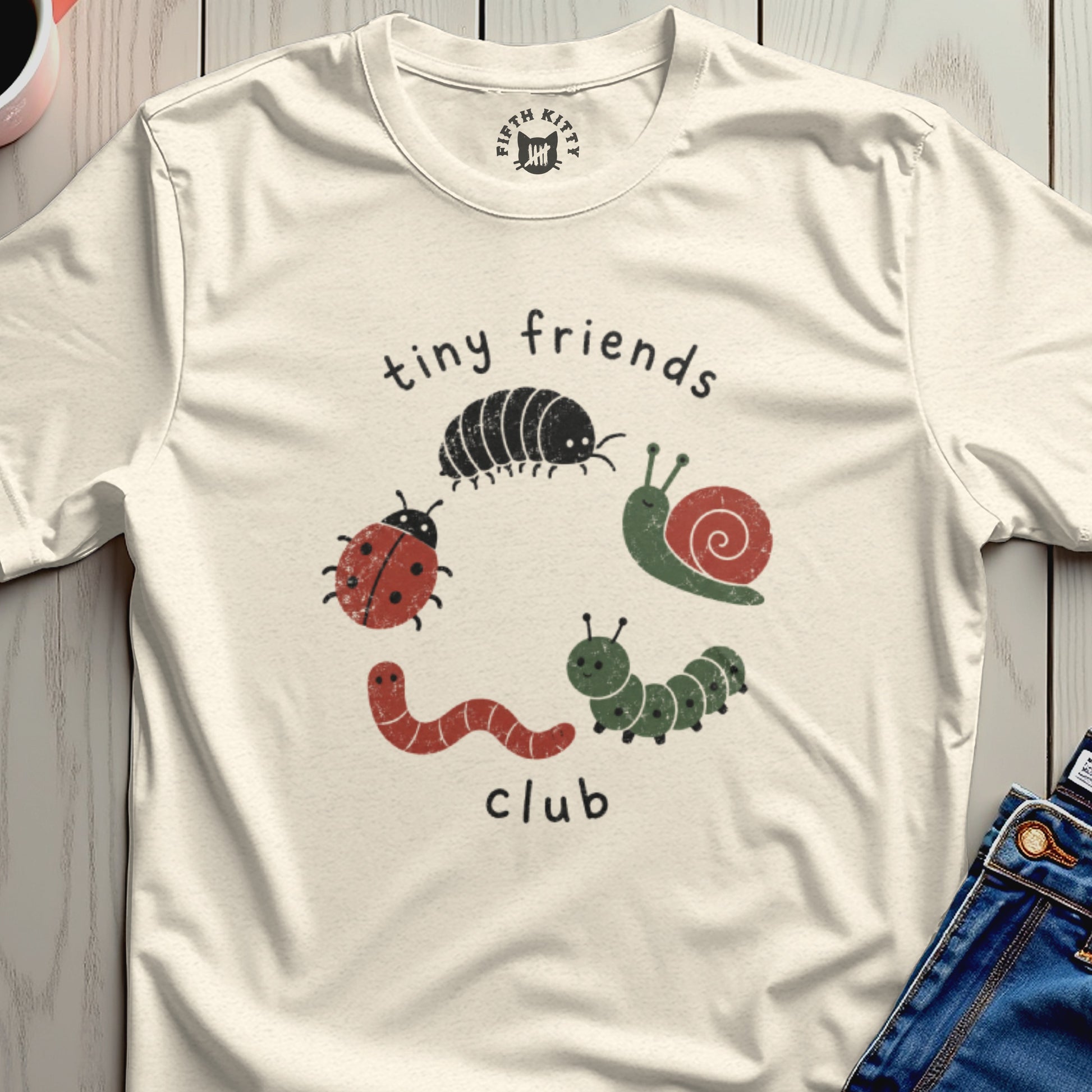 T-shirt with 'tiny friends club' text and cartoon bugs: ladybug, worm, caterpillar, snail, and pill bug.
