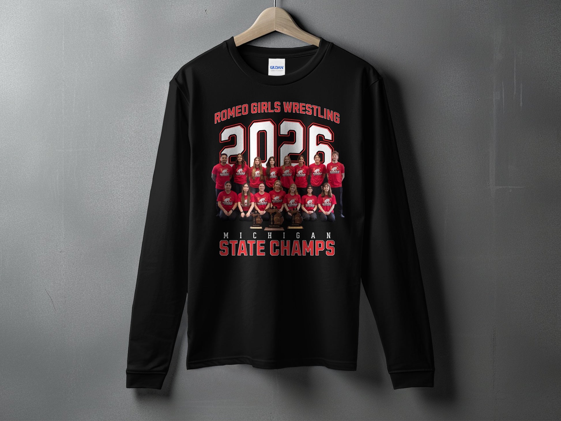 Black sweatshirt with "Romeo Girls Wrestling 2026 Michigan State Champs" and team photo.