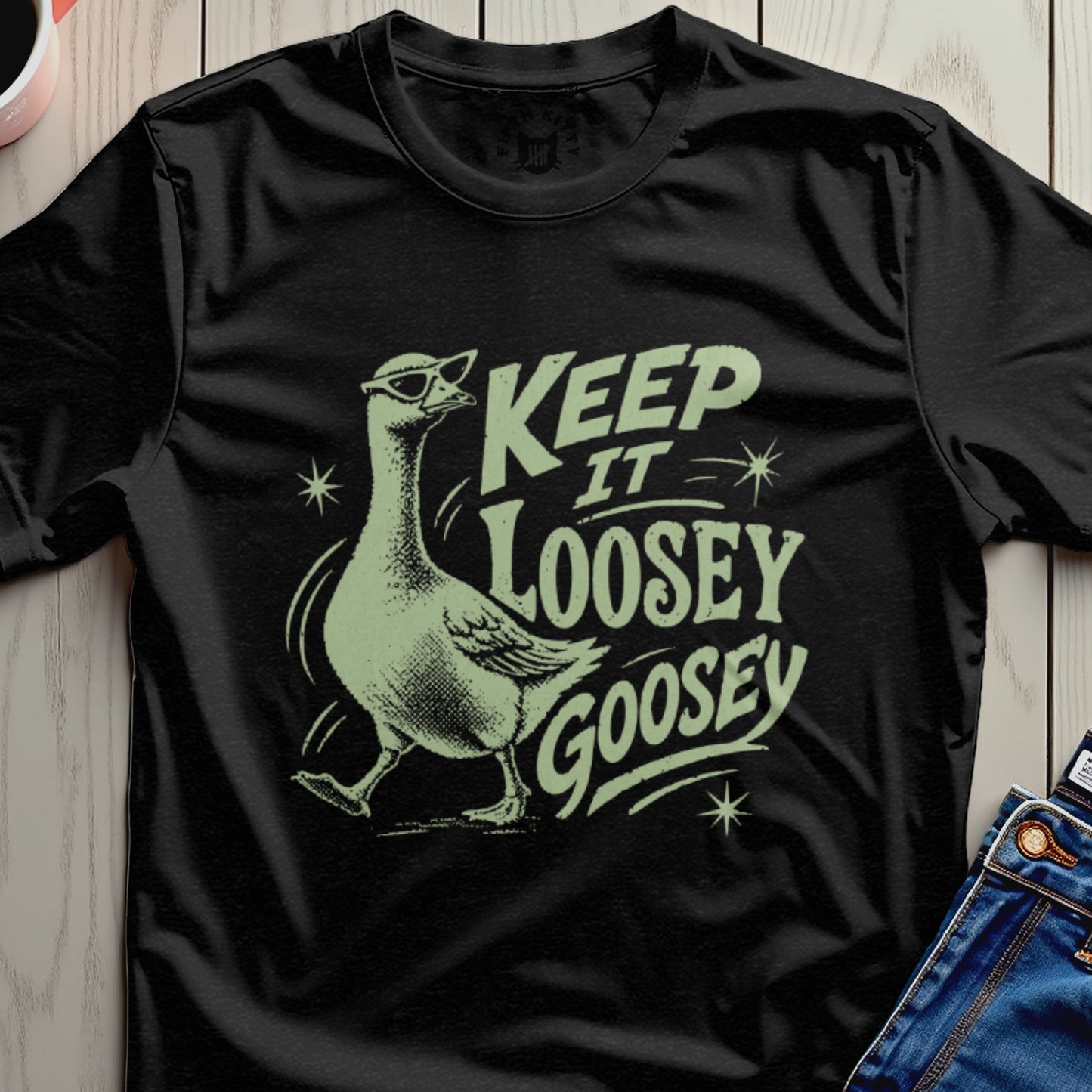 Black t-shirt with a light green graphic of a goose wearing sunglasses and text.