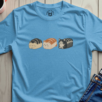 Three loaf-shaped cats in cartoon style on a blue t-shirt with Fifth Kitty logo.