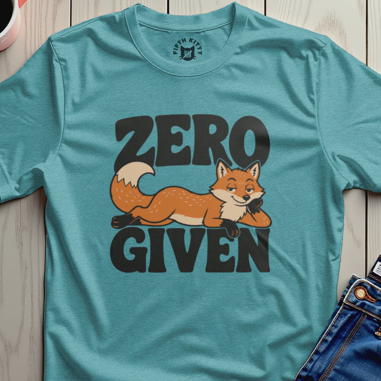Teal t-shirt with a relaxed fox illustration and the text "ZERO GIVEN".