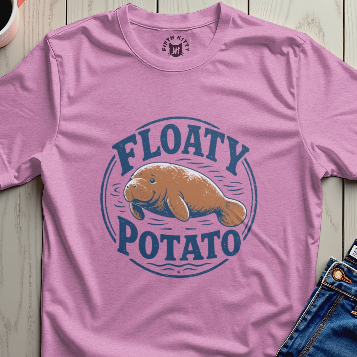 Pink t-shirt with blue "Floaty Potato" text and manatee graphic.