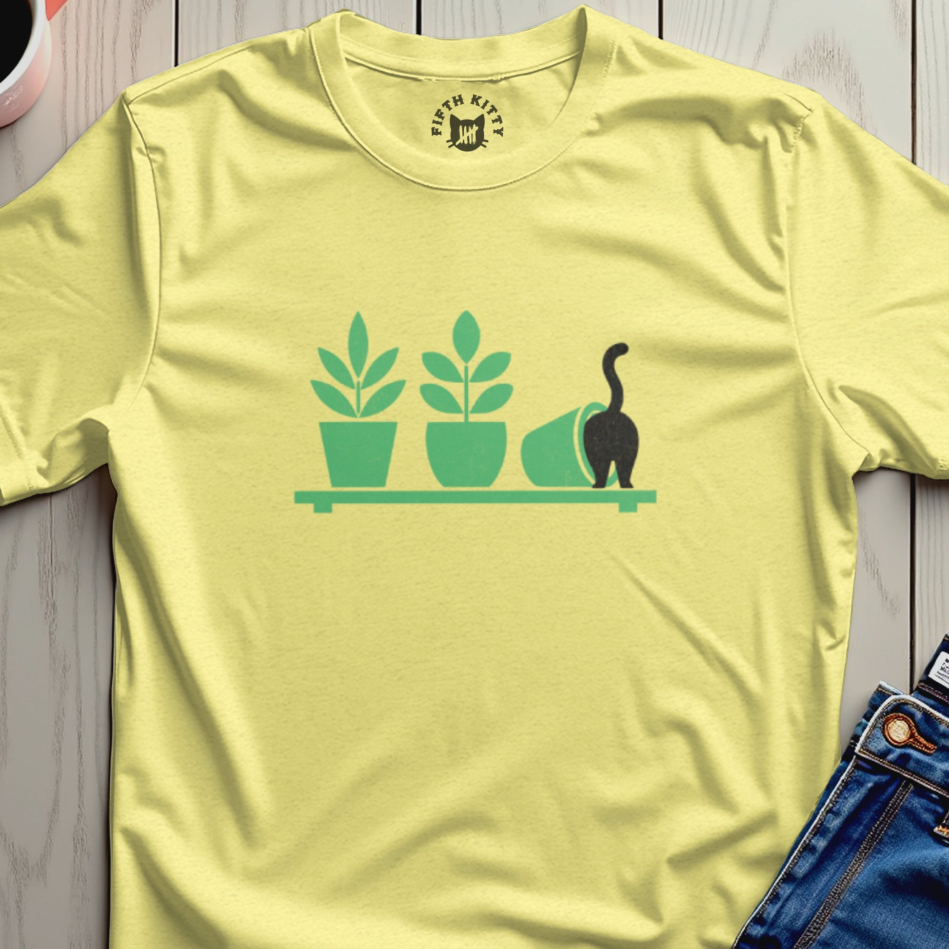 Yellow t-shirt with a minimalist graphic of potted plants and a cat's tail.