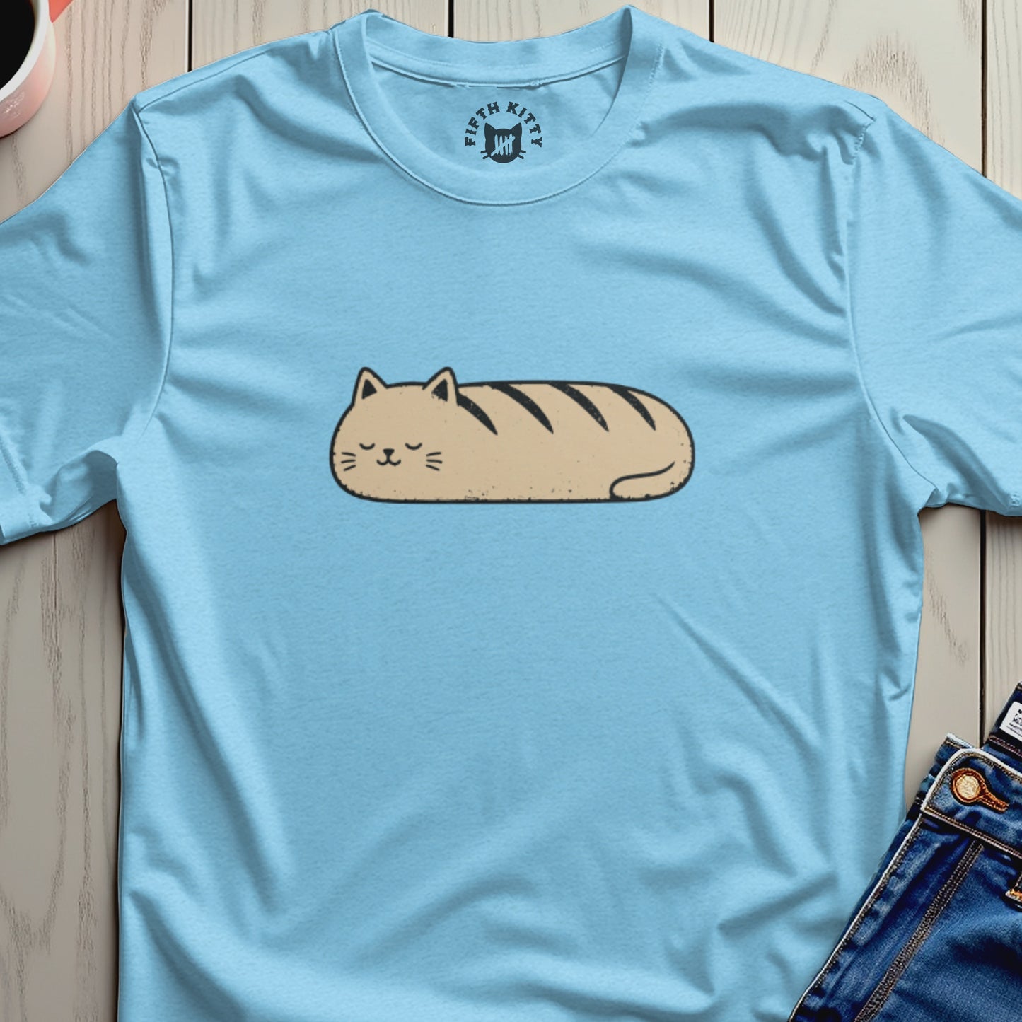 Light blue t-shirt with a brown loaf cat graphic and "FIFTH KITTY" logo.