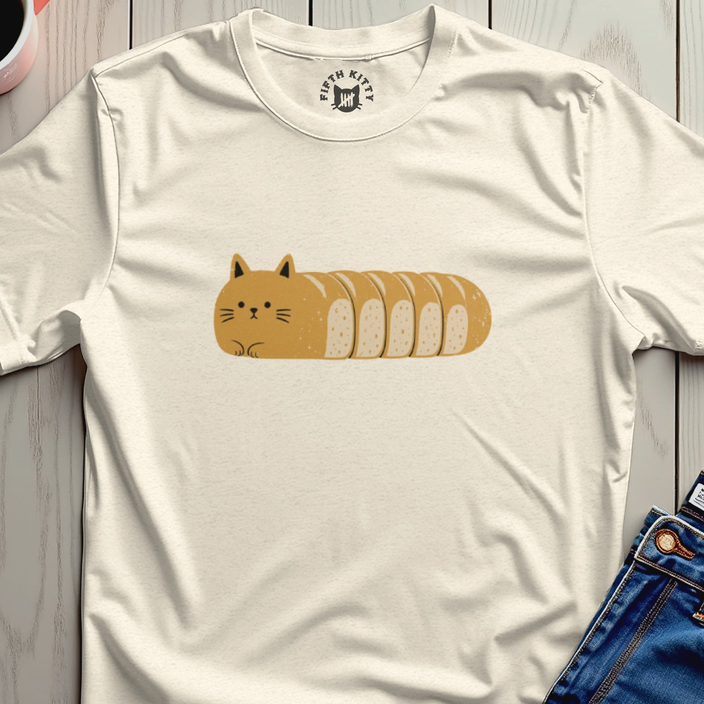 Cream t-shirt with a cartoon illustration of a cat-shaped loaf of bread.