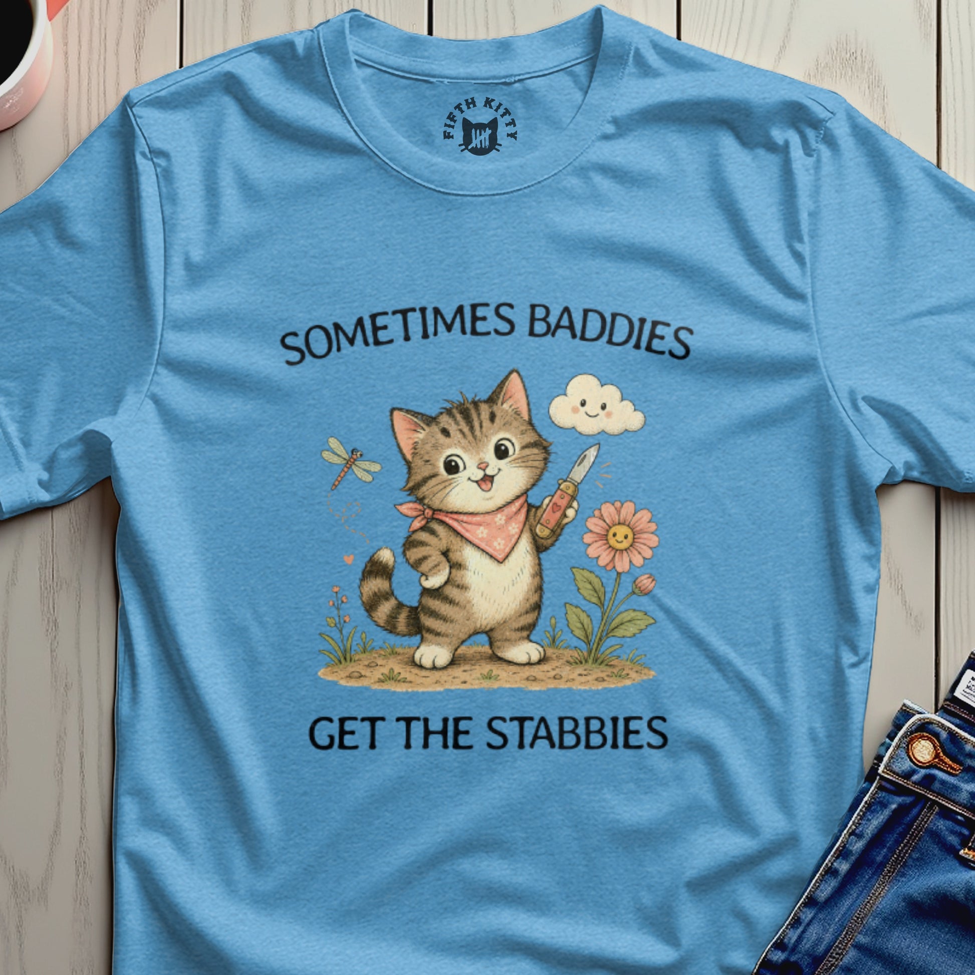 T-shirt with a cartoon cat holding a knife and text "Sometimes baddies get the stabbies".