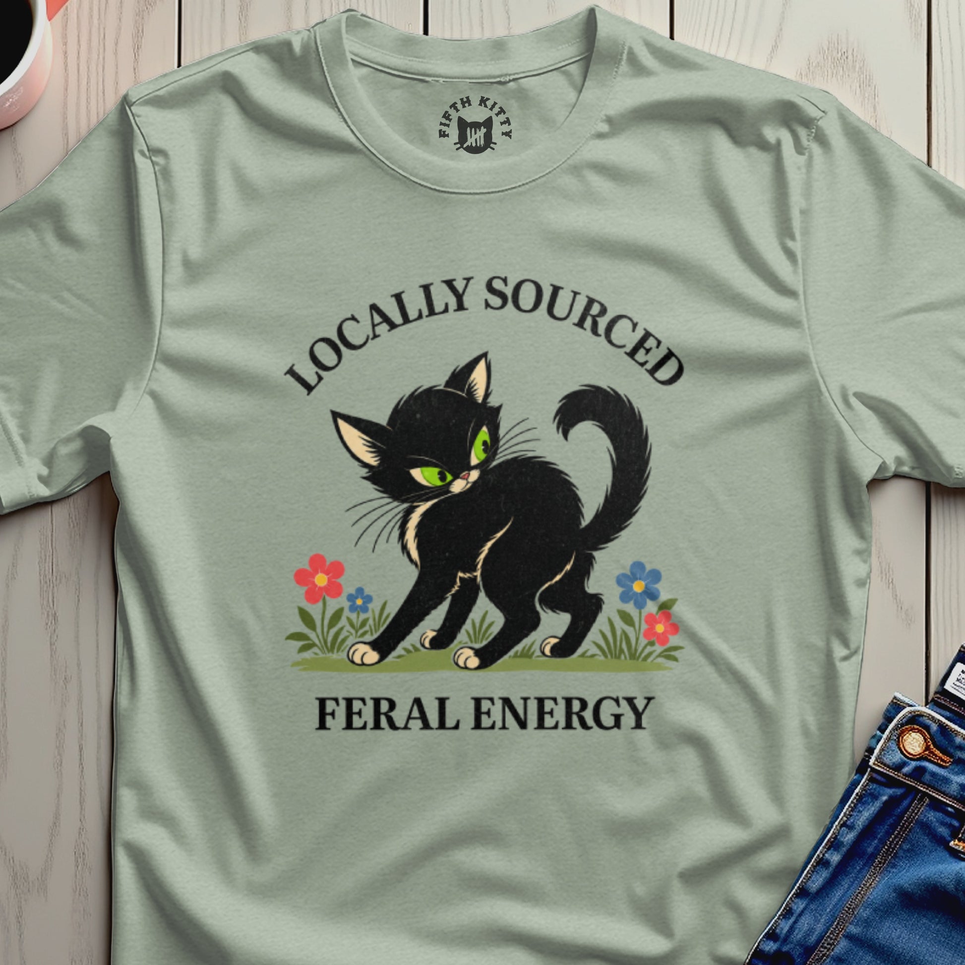 Black cat with green eyes and "Locally Sourced Feral Energy" text.