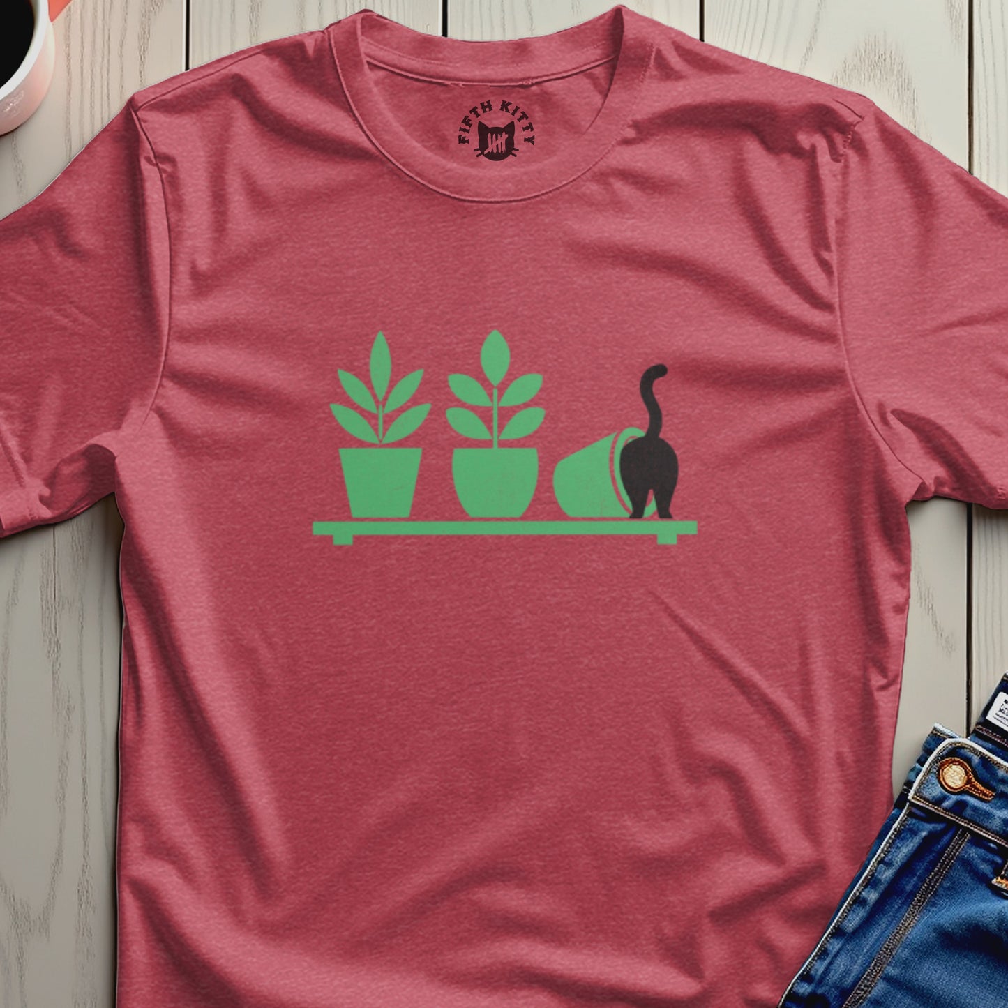 Red t-shirt with green cat and potted plants graphic.