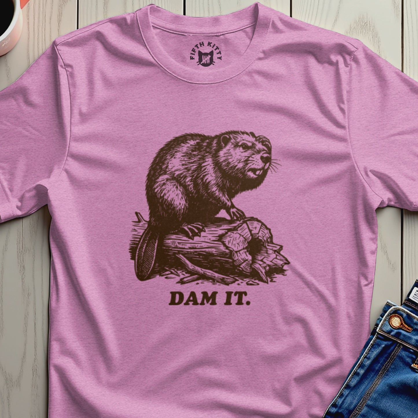 Beaver on wood log with "DAM IT." text on pink t-shirt.