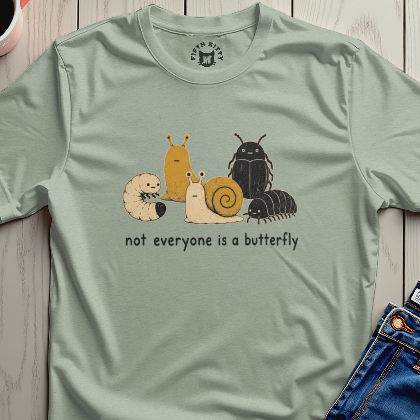 Light green t-shirt with cartoon caterpillars, slugs, beetles, and isopods, and text "not everyone is a butterfly".