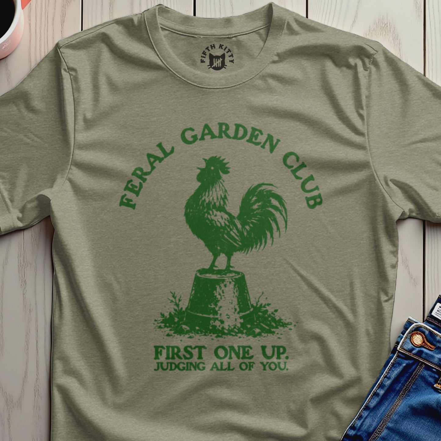 Green t-shirt with rooster graphic and text "Feral Garden Club First One Up. Judging All of You."