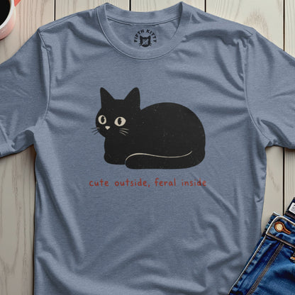Blue t-shirt with a black cat graphic and text "cute outside, feral inside".